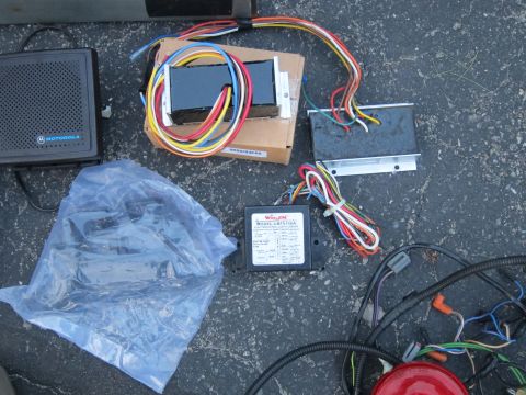 1991 Ford LTD Crown Victoria - Assorted electronic parts including a Motorola speaker and Whelen amplifier with wiring.