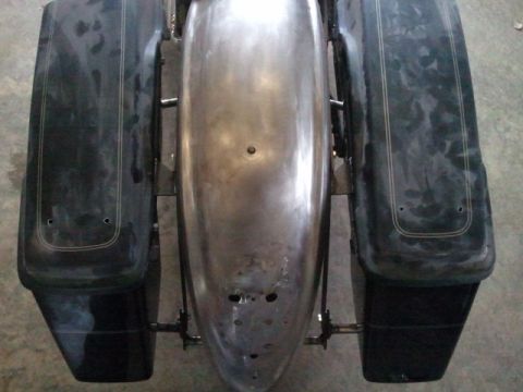 1995 Ford F-150 - Unpainted metal motorcycle fender and black saddlebags are shown from a top-down perspective.
