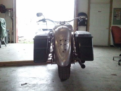 1995 Ford F-150 - This motorcycle is viewed from the rear, showing its saddlebags and a custom fender with drilled holes.