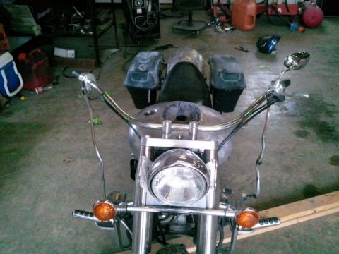 1995 Ford F-150 - Front view of a motorcycle's handlebars, headlight, and turn signals in a workshop setting.