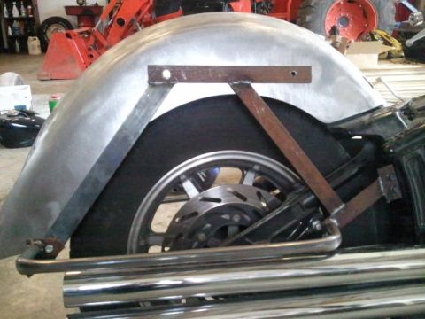 1995 Ford F-150 - A motorcycle's rear wheel and custom fender are shown, with chrome exhaust pipes in the foreground.
