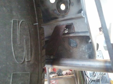 1995 Ford F-150 - Detail of a truck's chassis and tire, with visible metalwork and hardware.