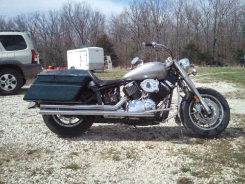 1995 Ford F-150 - A custom cruiser motorcycle is parked on a gravel lot with a trailer and SUV in the background.