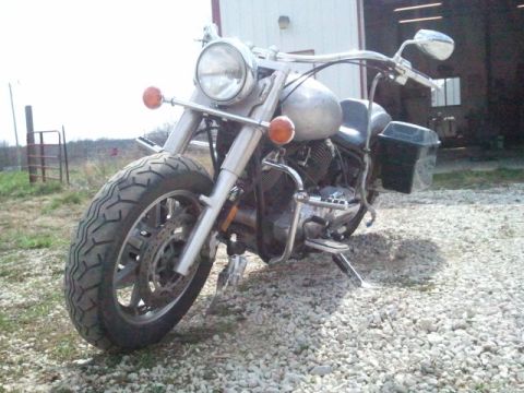 1995 Ford F-150 - This motorcycle is parked on a gravel surface in front of a building.