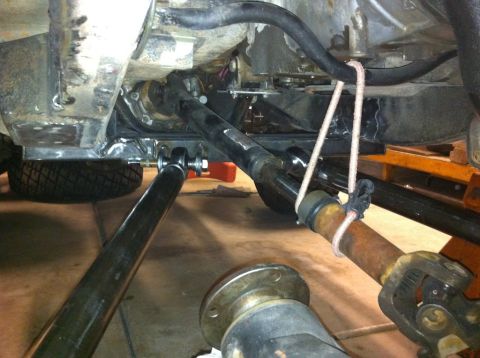 1987 Suzuki Samurai - Close-up view of the undercarriage, focusing on the front axle and suspension components.