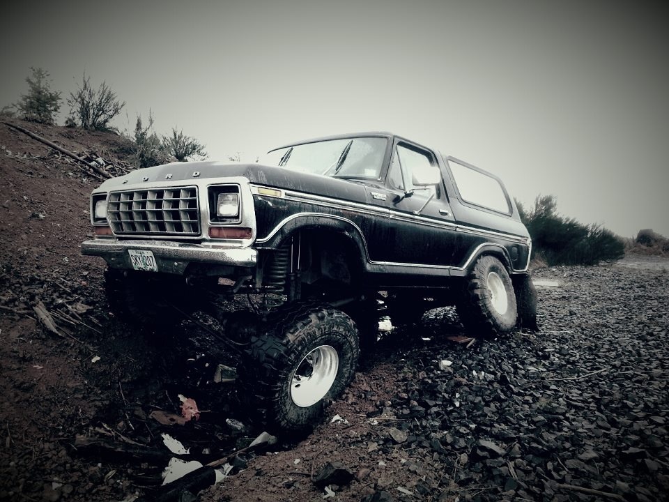 Black Ford Bronco with lifted suspension on rocky terrain