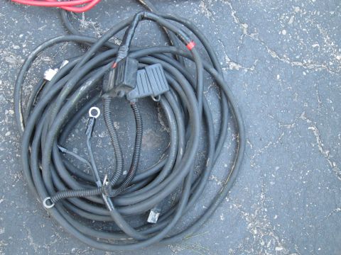 1991 Ford LTD Crown Victoria - Automotive wiring harness with multiple connectors and ring terminals, coiled on a paved surface.