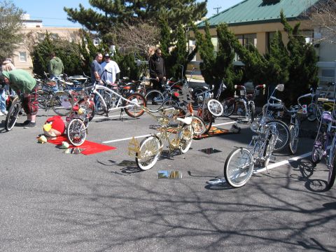 1994 Ford Bronco - A collection of custom bicycles are displayed outdoors, with people gathered around them.