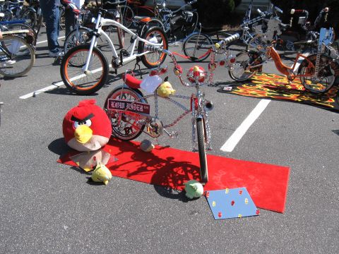 1994 Ford Bronco - A custom lowrider bicycle is displayed on a red carpet with an Angry Bird plush toy.