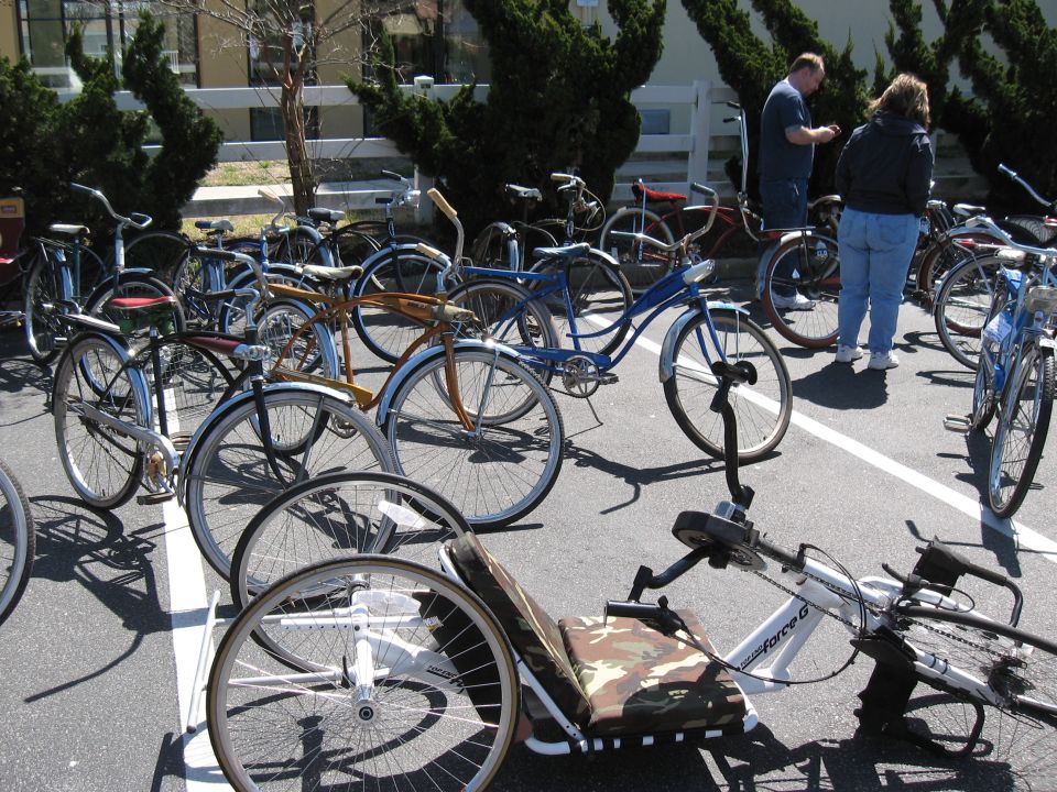 Various bicycles and a recumbent tricycle parked outdoors