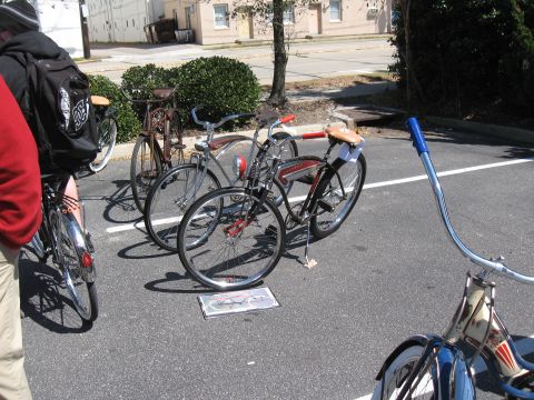 1994 Ford Bronco - Multiple vintage bicycles are displayed outdoors in a paved area with parking lot lines.