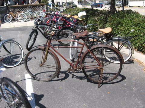 1994 Ford Bronco - A collection of bicycles, including a prominent vintage model, are parked outdoors.
