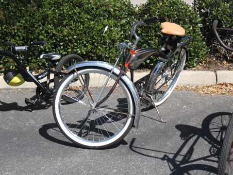 1994 Ford Bronco - Two bicycles are parked outdoors, one a vintage cruiser and the other a modern bike.