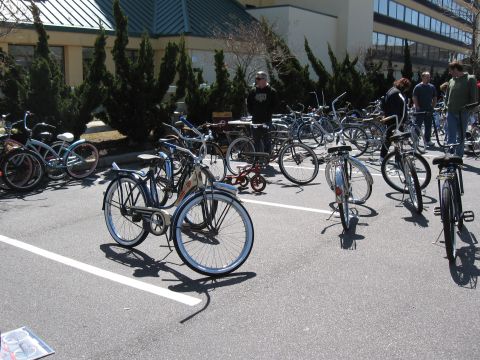 1994 Ford Bronco - A variety of bicycles and a tricycle are displayed in an outdoor parking lot.