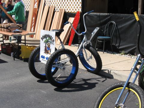 1994 Ford Bronco - A tricycle with a sign is parked on the street, with other bicycles visible.