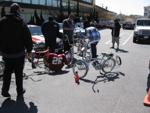 1994 Ford Bronco - People admire custom lowrider bicycles displayed in a sunny outdoor gathering.