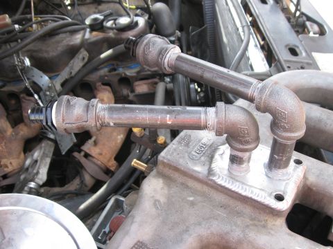 1981 Ford Bronco - Custom intake pipes are attached to a component on the engine.
