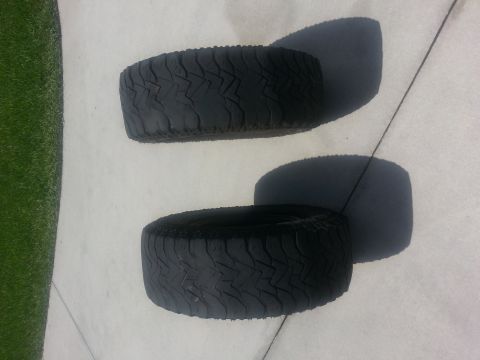 1994 Ford Bronco - Two off-road tires are shown, each with a distinct, aggressive tread pattern.