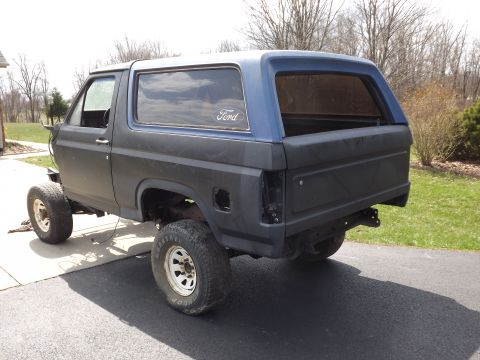 1981 Ford Bronco - This 1981 Ford Bronco is shown from the rear, lifted with off-road tires and a blue hardtop.