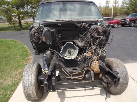 1981 Ford Bronco - Front view of a disassembled 1981 Ford Bronco chassis, showing the engine bay and suspension components.