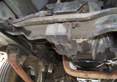 1994 Ford F-150 - This photo shows the underside of a vehicle, focusing on the frame and drivetrain components with visible rust.