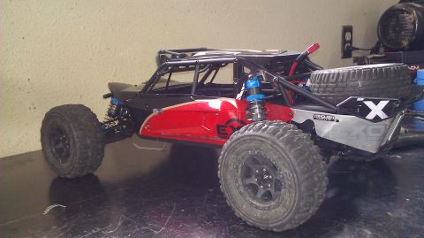 1996 Ford Bronco - This remote control rock crawler buggy features a roll cage, exposed suspension, and a spare tire mounted on the rear.