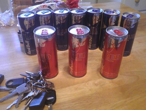 2003 Ford Crown Victoria - Several Red Bull energy drink cans and a bunch of keys are scattered on a wooden table.