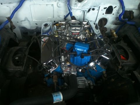 1973 Ford Ranchero - Close-up view of a V8 engine with chrome accents and blue ignition components.