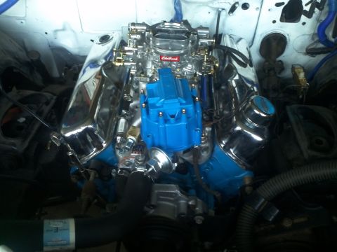 1973 Ford Ranchero - The engine bay features a V8 engine with polished chrome components and a bright blue distributor cap.