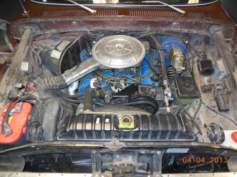 1979 Ford F-150 - Engine bay of a 1979 Ford F-150, a blue engine block and a prominent chrome air cleaner assembly.
