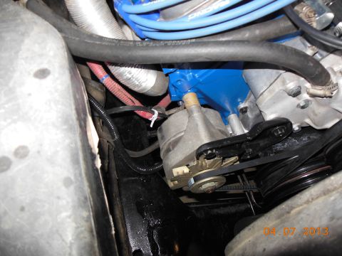 1979 Ford F-150 - Close-up of engine components, including an alternator and a bright blue painted part, with a visible date stamp of 04-07-2013.