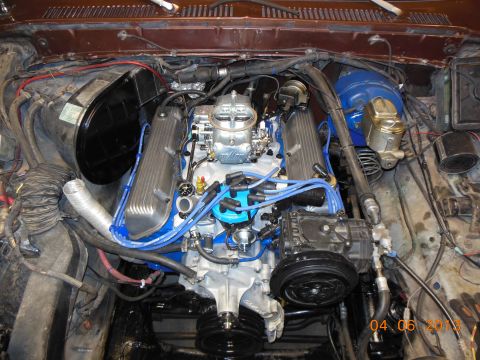 1979 Ford F-150 - Engine compartment showing a Ford V8 with chrome carburetor, blue valve covers and plug wires, A/C compressor, dated 04-06-2013.