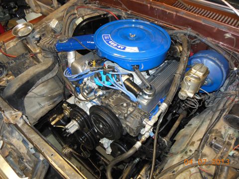 1979 Ford F-150 - Engine bay view of a Ford 460-4V V8 with a bright blue round air cleaner labeled '460-4V' and matching blue valve covers, showing blue spar…