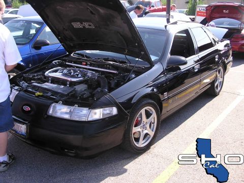 1993 Ford Taurus - Black 1993 Ford Taurus SHO at a car meet, hood up to display the engine bay.