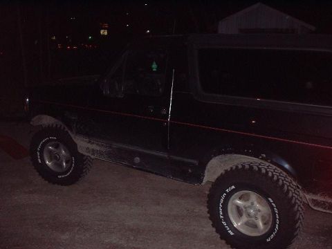 1993 Ford Bronco - Side view of a 1993 Ford Bronco parked outdoors at night.