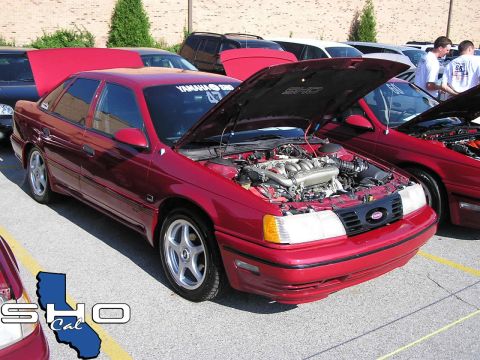 1993 Ford Taurus - Red 1993 Ford Taurus SHO at a car show with hoods open.
