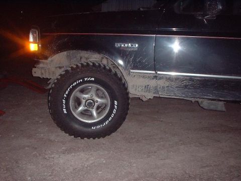 1993 Ford Bronco - The side of a dirty 1993 Ford Bronco is shown, its BFGoodrich tires and a "BRONCO" badge.