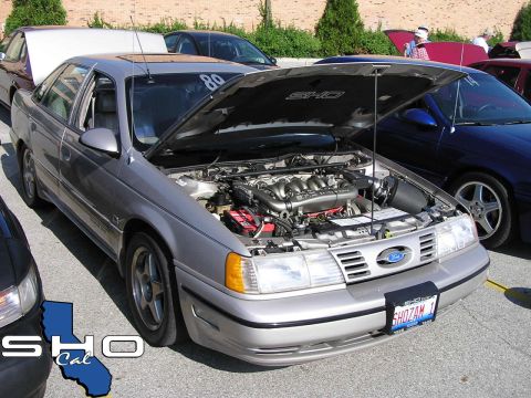 1993 Ford Taurus - Silver 1993 Ford Taurus SHO at a car meet, hood open to display the engine and interior details.