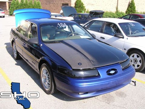 1993 Ford Taurus - Modified 1993 Ford Taurus at a car show, a carbon fiber hood and custom blue trunk.