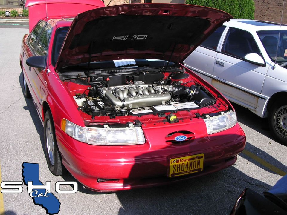 Red 1992 Ford Taurus SHO with hood open, showing V8 engine. Iowa license plate reads SHO4MON