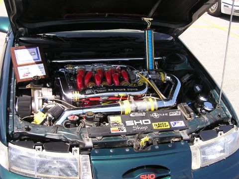 1993 Ford Taurus - Customized engine bay a SHO 24 Valve DOHC engine, complete with a trophy and awards displayed.