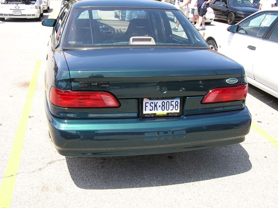 Dark green sedan's rear bumper with SHO badging and license plate FSK-8058