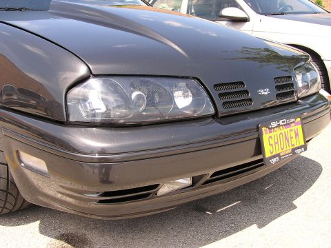 1993 Ford Taurus - Front view of a 1993 Ford Taurus SHO, custom headlights and a personalized license plate.