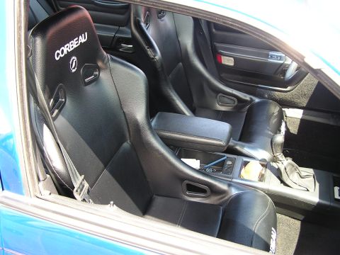 1993 Ford Taurus - Interior view of a car aftermarket Corbeau racing seats and a gear shifter.