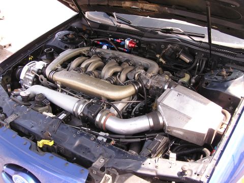 1993 Ford Taurus - Modified V8 engine bay with aftermarket turbo and intercooler components.