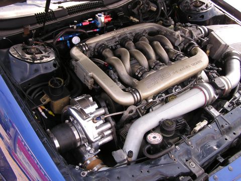 1993 Ford Taurus - The engine bay features a SHO 3.0L 24 valve DOHC engine with a prominent turbocharger and custom plumbing.