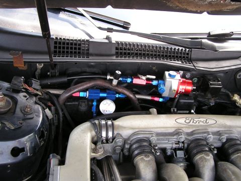 1993 Ford Taurus - Custom fuel system components are visible in the engine bay, alongside a Ford branded engine cover.