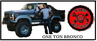 1984 Ford Bronco - A blue Ford Bronco is shown with a man standing beside it, next to an off-road club logo.