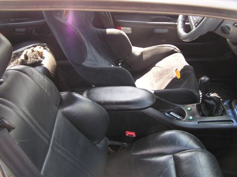 1993 Ford Taurus - Interior view of a 1993 Ford Taurus, showing front seats and a child car seat.
