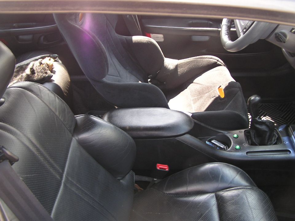 Black leather seats and a child car seat in a 1993 Ford Taurus interior